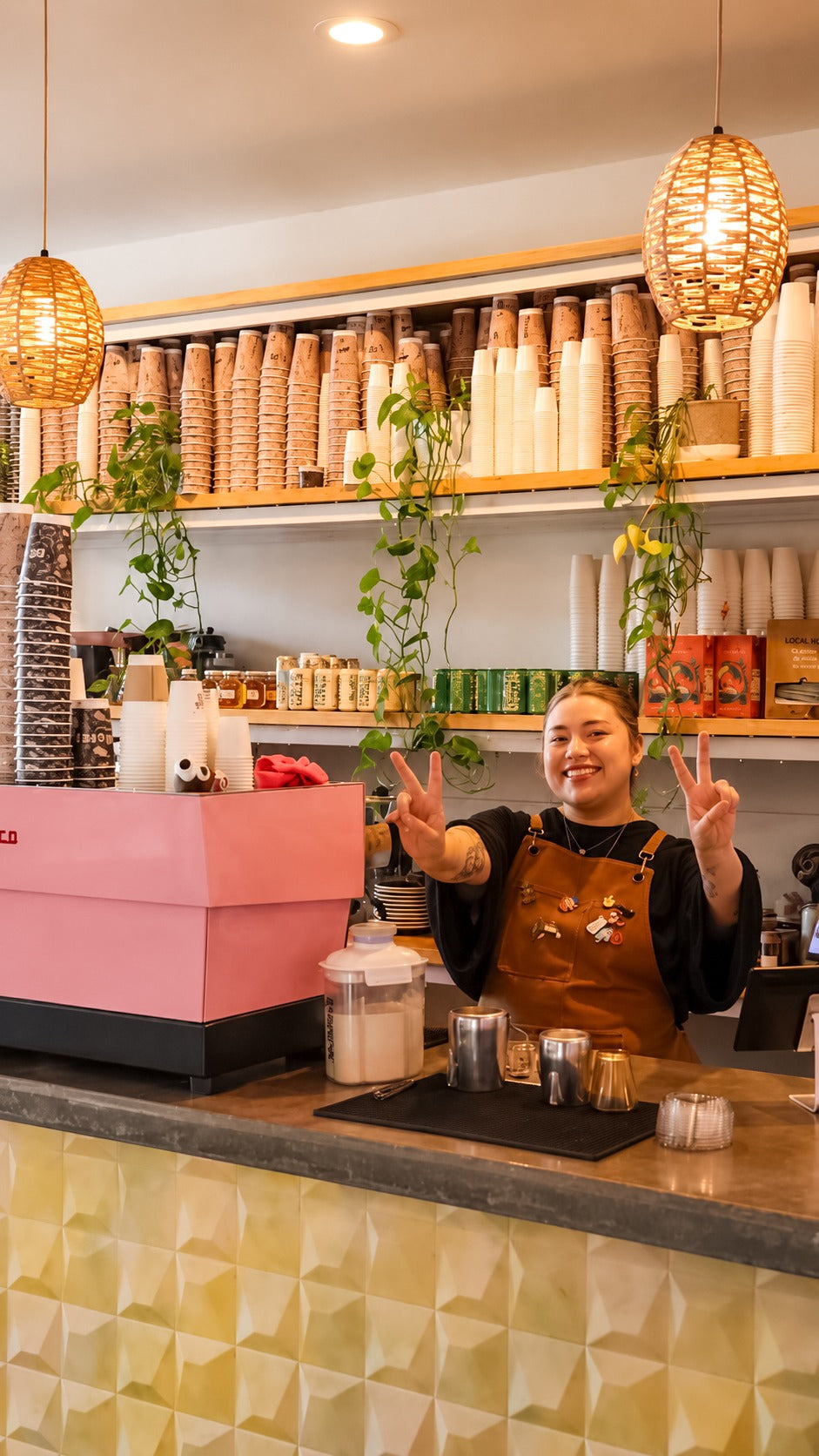 A smiling Berni Bean team member behind the coffee bar
